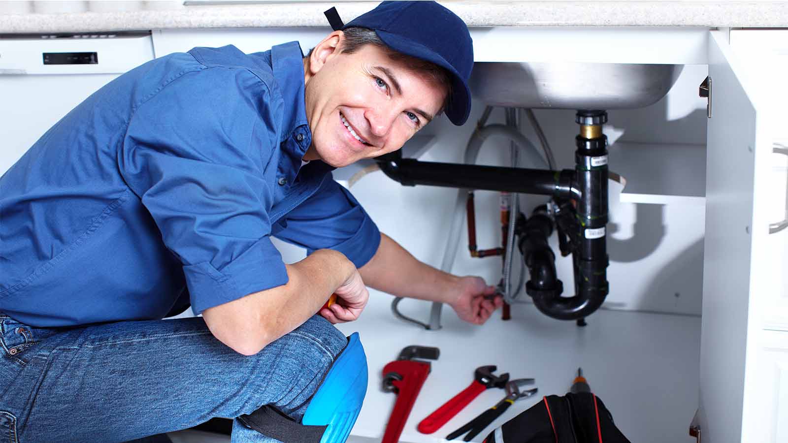 Plumber working on pipe
